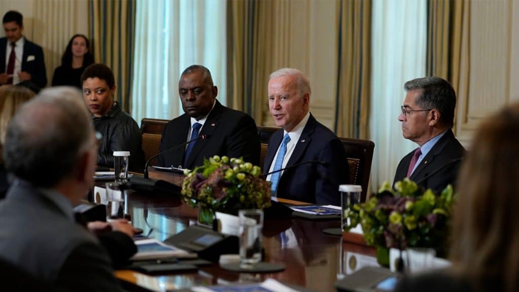 President Joe Biden, seated, has praised his administration for slowing the rate at which the government accumulates new debt