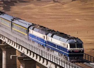 China e Irán activan nueva ruta ferroviaria de carga Tren de carga con contenedores circula por un puente en una zona desértica.
