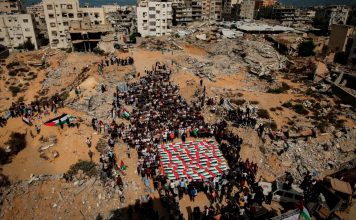 Gaza permanece bajo ataques pese a un año de alto al fuego Familiares se reúnen alrededor de los restos cubiertos con banderas de palestinos muertos en ataques israelíes.