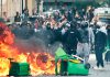 Protestas estudiantiles sacuden Francia y dejan más de 6.100 detenidos Estudiantes participan en una protesta entre humo y contenedores incendiados en París.